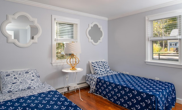 bedroom with hardwood / wood-style flooring, crown molding, and a baseboard radiator