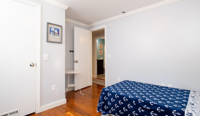 bedroom featuring hardwood / wood-style flooring and ornamental molding