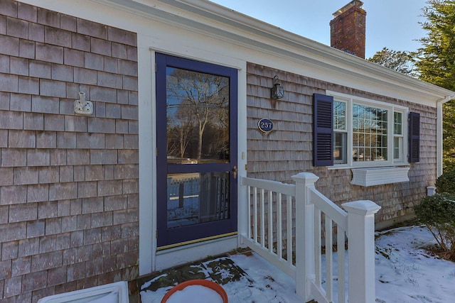 view of snow covered property entrance