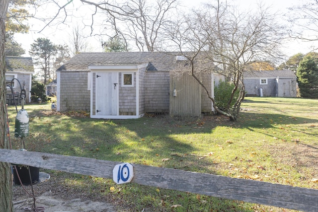 view of outdoor structure featuring a lawn