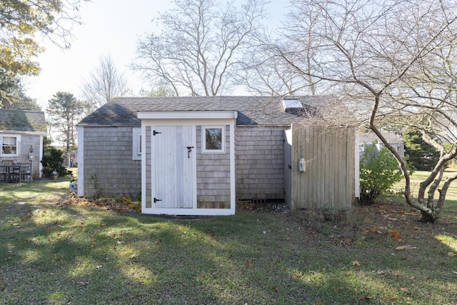 view of outdoor structure featuring a lawn