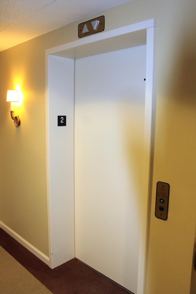 110 Dillingham Ave Unit 215U, Falmouth, MA 02540 - corridor with elevator, dark carpet, and baseboards