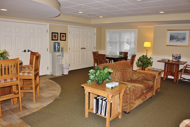 110 Dillingham Ave Unit 215U, Falmouth, MA 02540 - living room featuring wainscoting, carpet, and a paneled ceiling