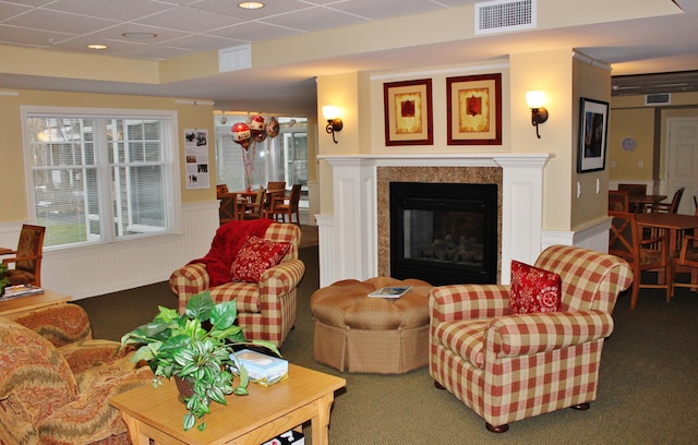 110 Dillingham Ave Unit 215U, Falmouth, MA 02540 - carpeted living area with a wainscoted wall, a decorative wall, and a glass covered fireplace