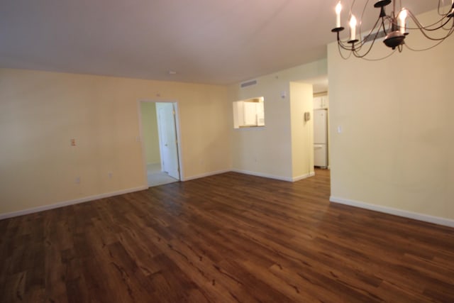 110 Dillingham Ave Unit 215U, Falmouth, MA 02540 - unfurnished room featuring a chandelier, dark wood finished floors, and baseboards