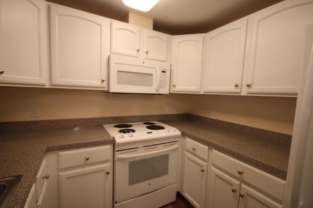 110 Dillingham Ave Unit 215U, Falmouth, MA 02540 - kitchen with white appliances, white cabinetry, and dark countertops