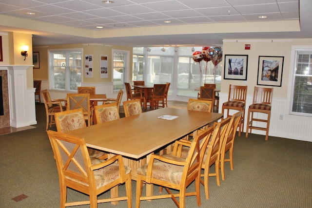 110 Dillingham Ave Unit 215U, Falmouth, MA 02540 - dining room featuring carpet flooring, wainscoting, a paneled ceiling, and a decorative wall