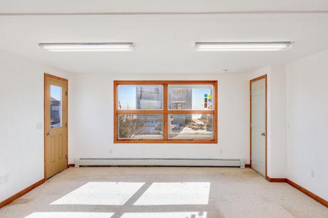 spare room with a baseboard radiator and light colored carpet