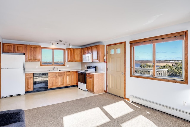 kitchen with sink, white appliances, and a baseboard heating unit