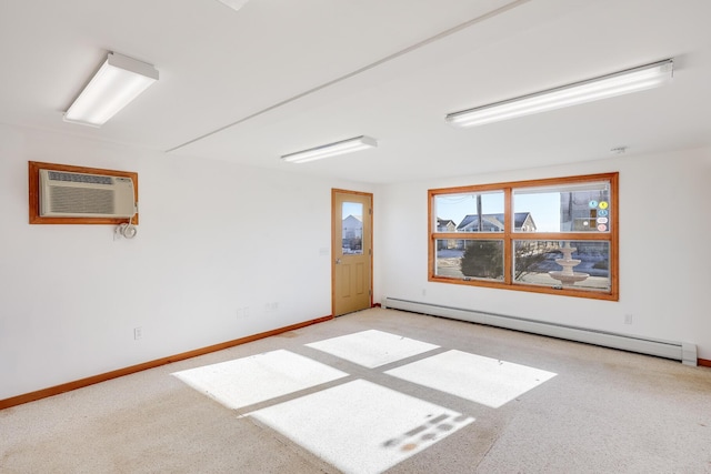 empty room featuring baseboard heating and an AC wall unit