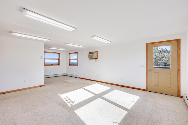 unfurnished room featuring baseboard heating and a wall mounted air conditioner