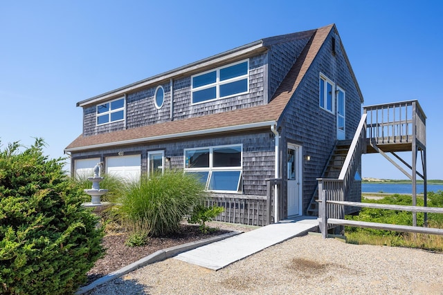 view of front of house featuring a garage and a water view