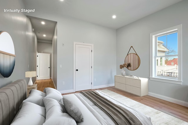 bedroom with baseboards, recessed lighting, and wood finished floors