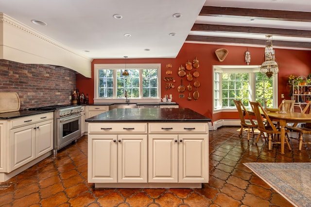 kitchen featuring high end range, dark stone countertops, a kitchen island, beam ceiling, and pendant lighting