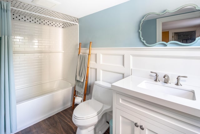 full bathroom with wood-type flooring, toilet, vanity, and shower / tub combo