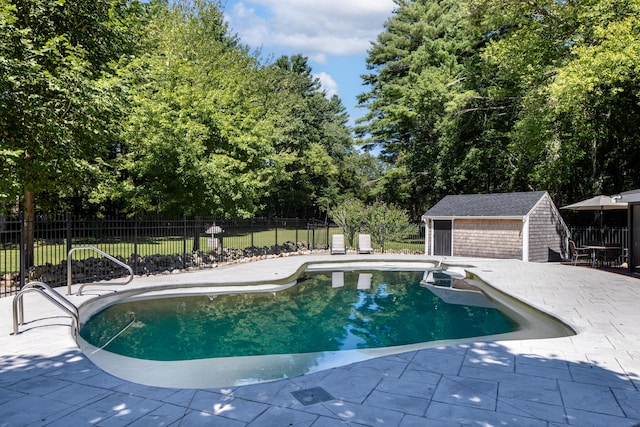 view of pool with a patio area and an outdoor structure