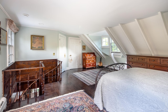 bedroom featuring baseboard heating, dark wood-type flooring, and vaulted ceiling