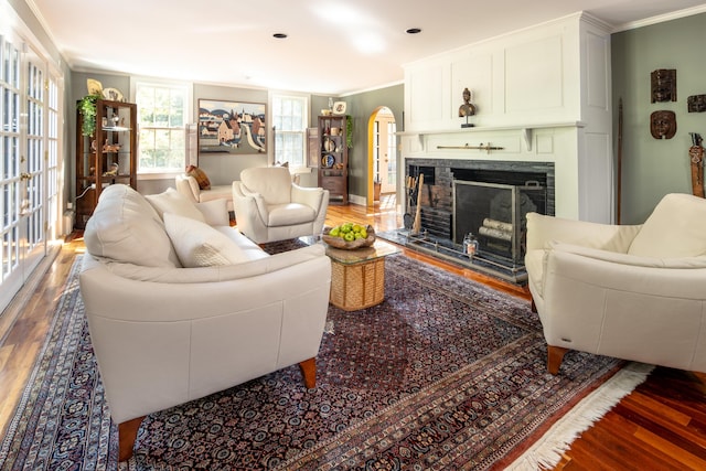 living room with crown molding and hardwood / wood-style floors