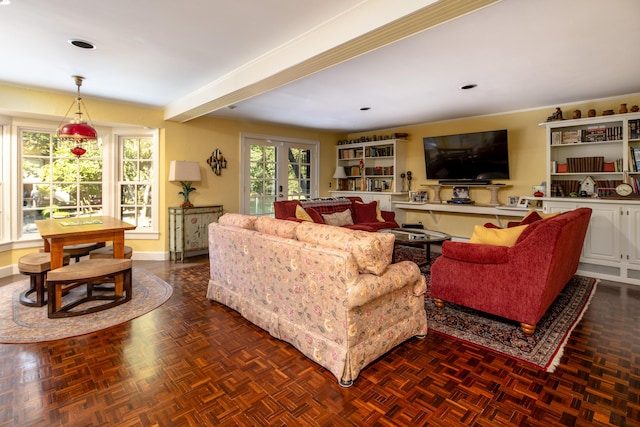 living room with dark parquet floors, beam ceiling, and french doors