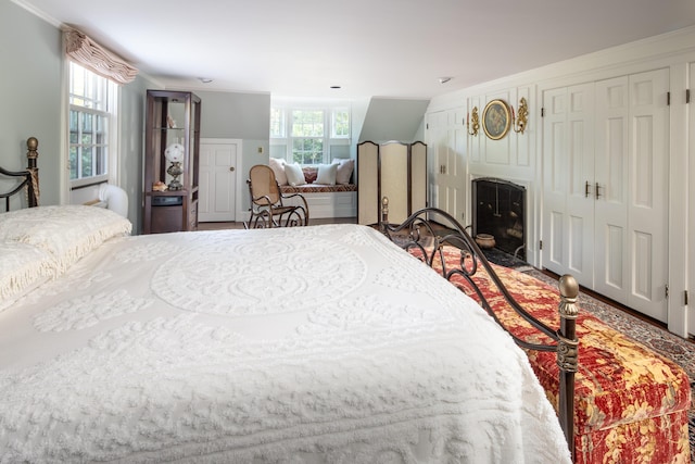 bedroom featuring multiple windows and crown molding