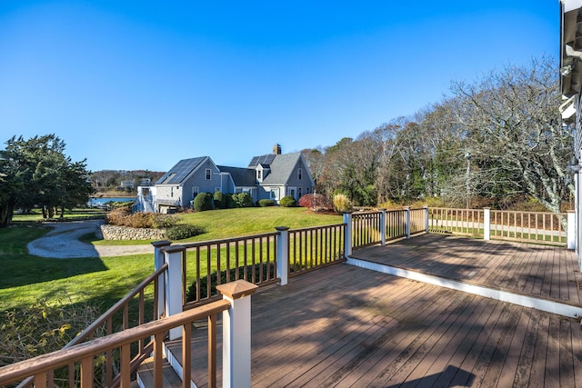 wooden terrace featuring a lawn