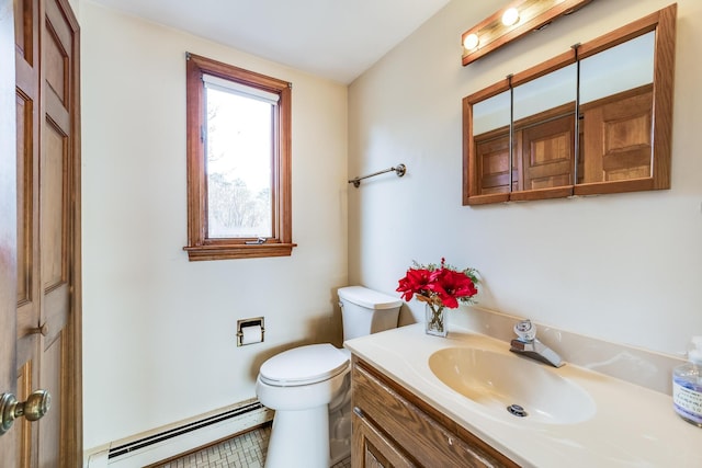 bathroom with vanity, baseboard heating, and toilet