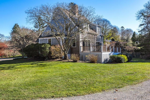 view of front of property with a front yard and a deck