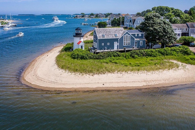 birds eye view of property with a beach view and a water view