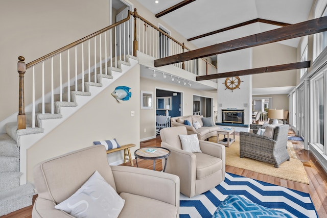 7 Dunes Rd, Harwich Port, MA 02646 - living room featuring high vaulted ceiling, wood finished floors, stairway, and beamed ceiling