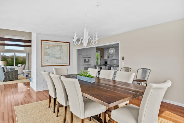 7 Dunes Rd, Harwich Port, MA 02646 - dining room with a chandelier and light wood-style floors