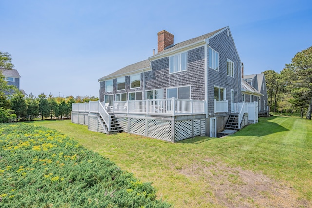 7 Dunes Rd, Harwich Port, MA 02646 - rear view of house featuring stairway, a chimney, a wooden deck, and a lawn
