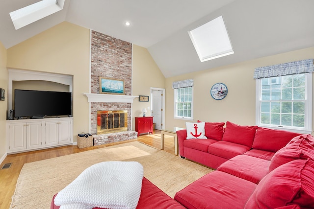 7 Dunes Rd, Harwich Port, MA 02646 - living room with a skylight, a fireplace, light wood-type flooring, high vaulted ceiling, and recessed lighting