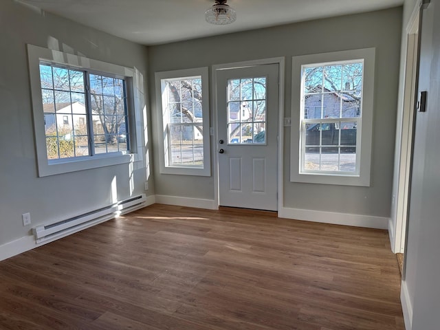 entryway featuring a baseboard heating unit and dark hardwood / wood-style flooring