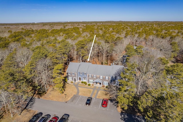 drone / aerial view featuring a view of trees