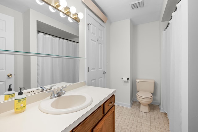 bathroom featuring vanity, toilet, baseboards, and visible vents