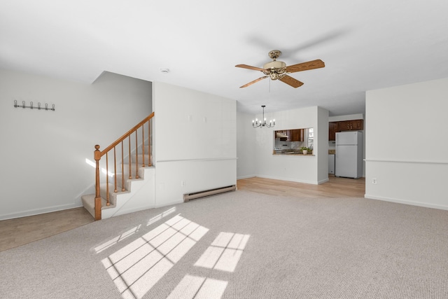 unfurnished living room featuring baseboards, stairway, light carpet, baseboard heating, and ceiling fan with notable chandelier