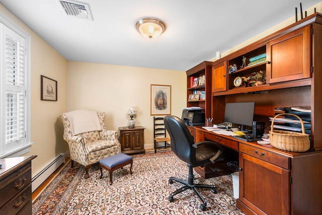 office space featuring a baseboard radiator and baseboards