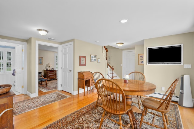 dining area with light wood finished floors, stairway, baseboards, recessed lighting, and a baseboard heating unit