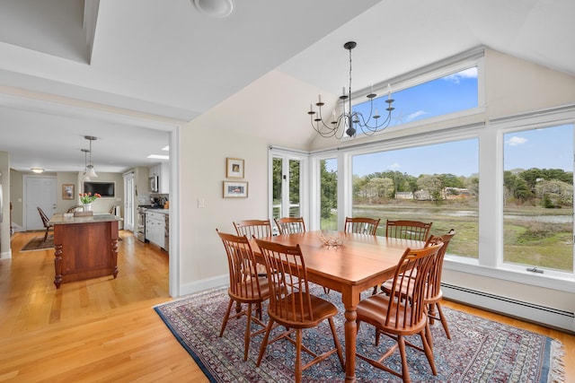 dining space with plenty of natural light, a baseboard radiator, light wood-type flooring, and lofted ceiling