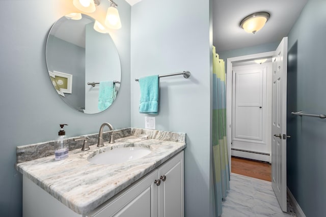 bathroom featuring a baseboard heating unit, marble finish floors, and vanity