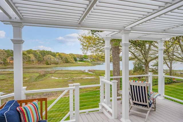 wooden deck featuring a water view, a pergola, and a yard
