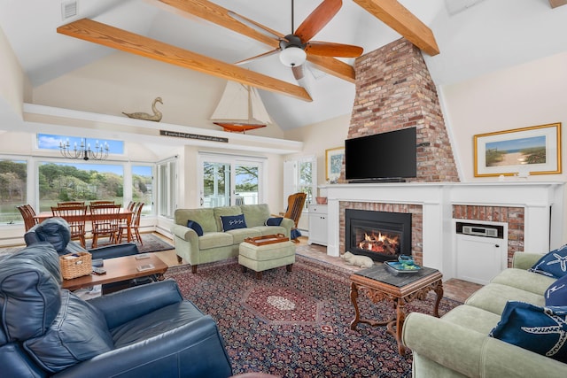 living area with a fireplace, beam ceiling, a chandelier, high vaulted ceiling, and ceiling fan
