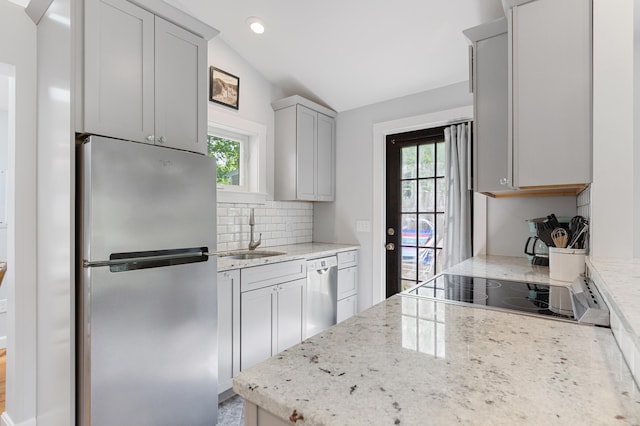 280 Schoolhouse Rd, Eastham, MA 02642 - kitchen featuring stainless steel appliances, a sink, healthy amount of natural light, vaulted ceiling, and tasteful backsplash