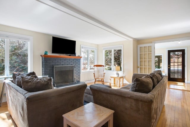 280 Schoolhouse Rd, Eastham, MA 02642 - living room featuring healthy amount of natural light, light wood-type flooring, and a brick fireplace