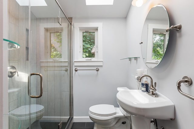 280 Schoolhouse Rd, Eastham, MA 02642 - bathroom featuring toilet, a skylight, and a stall shower