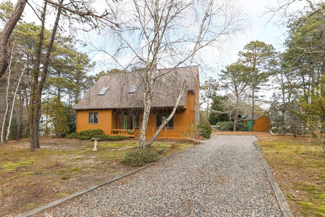 view of front of home with a storage shed