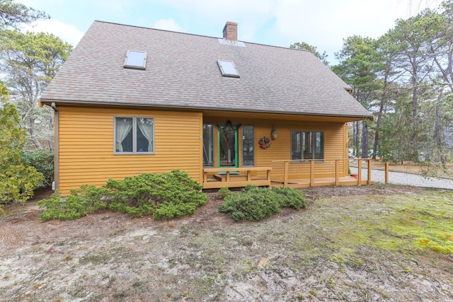 35 Pine Field Rd, Wellfleet, MA 02667 - rear view of property with a chimney, a shingled roof, and a wooden deck