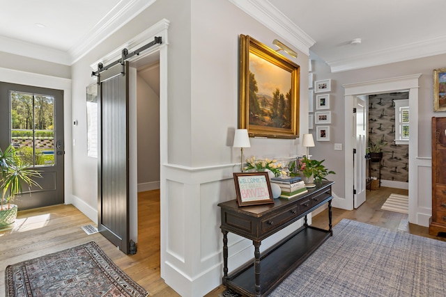 27 Gully Ln, East Sandwich, MA 02537 - hall with a barn door, light wood-type flooring, healthy amount of natural light, and crown molding