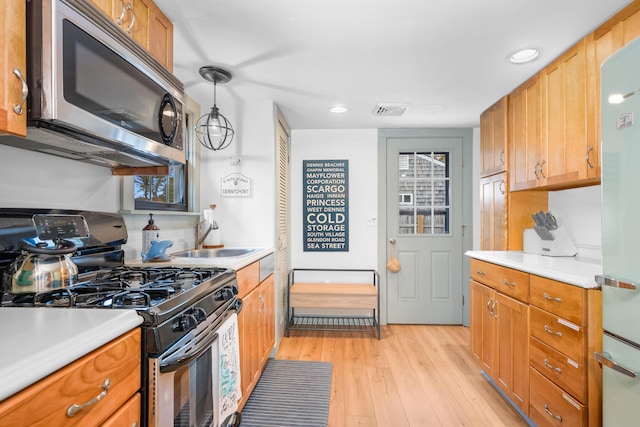 22 Wixon Rd, Dennis Port, MA 02639 - kitchen with appliances with stainless steel finishes, light countertops, light wood-type flooring, recessed lighting, and pendant lighting