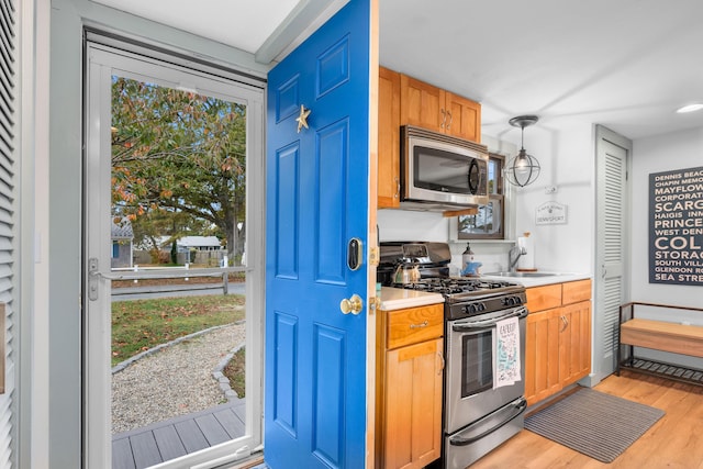 22 Wixon Rd, Dennis Port, MA 02639 - kitchen with stainless steel appliances, light wood-type flooring, light countertops, and hanging light fixtures